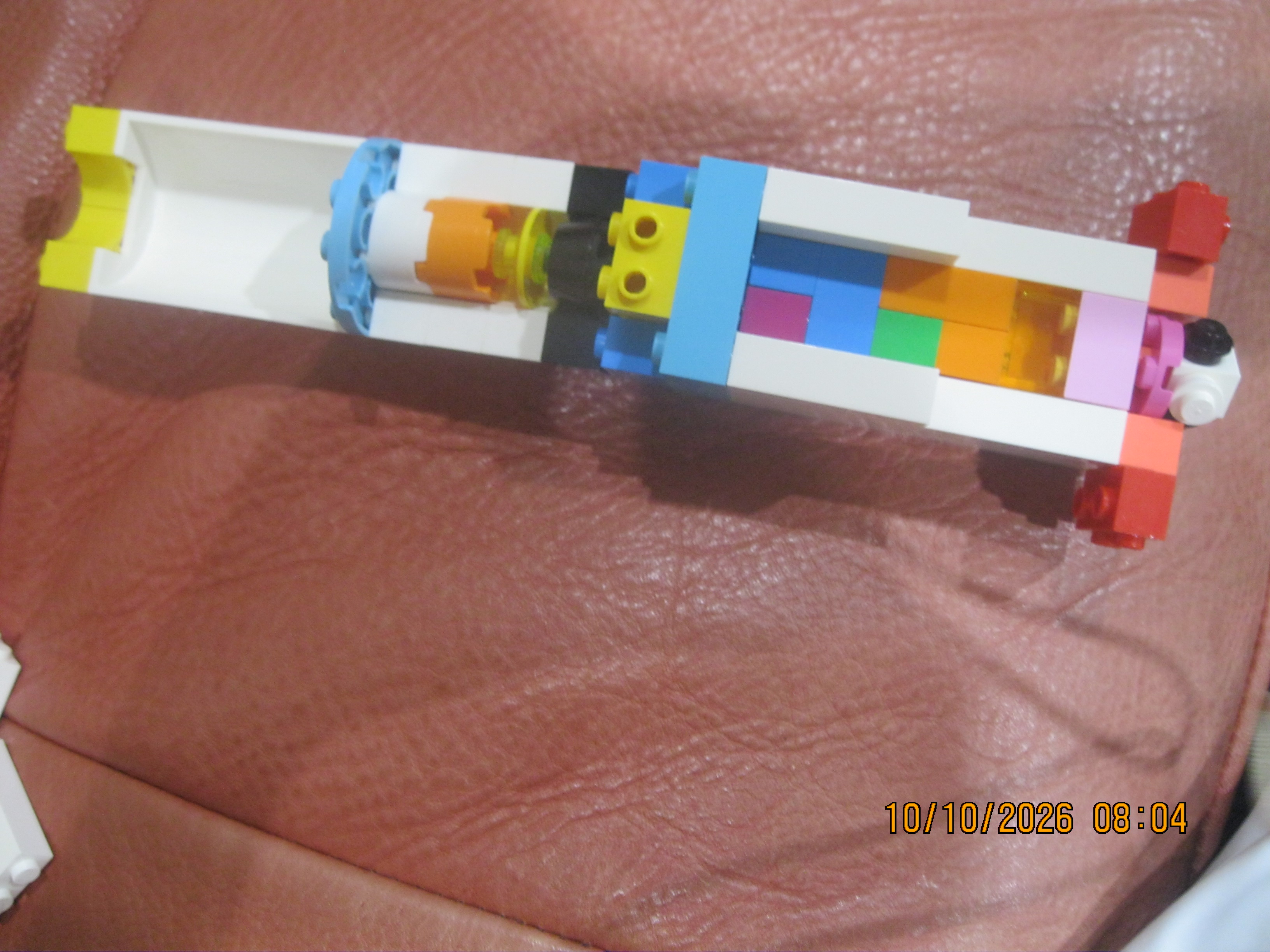 A LEGO rocket opened lengthwise to show its colorful internal sections